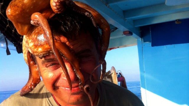 Rosario, our Favignana,Sicily boat captain being his fun-loving self with his new best friend, Mr. Octopi! 